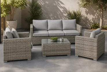 Outdoor wicker patio furniture set with gray cushions and glass-top table.